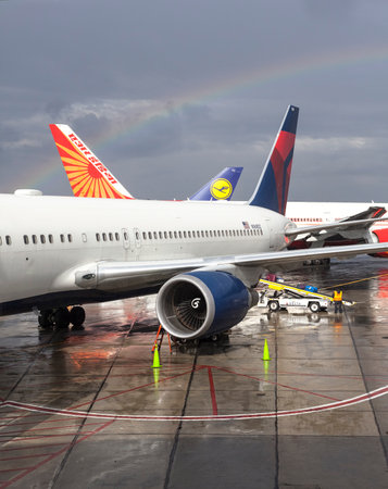 Newark, USA - September 13, 2015: Rainbow over three airplanes at Newark Liberty International Airport (EWR). Airport is a major hub for United Airlines, the airport's largest tenant.のeditorial素材