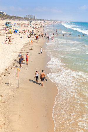 Santa Monica, USA - August 22, 2015: People resting on beach during peak season. Santa Monica had become famous resort town by the early 20th century.のeditorial素材