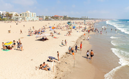 Santa Monica, USA - August 22, 2015: People resting on beach during peak season. Santa Monica had become famous resort town by the early 20th century.のeditorial素材