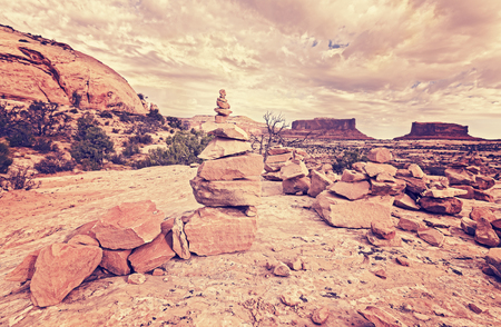 Retro stylized trail stone footpath mark in Canyonlands National Park, Island in the Sky district, Utah, USA.の写真素材