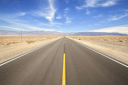 Endless country highway in Death Valley, travel adventure concept, USA.