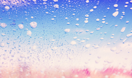 Abstract background made of blurred soap bubbles on glass.