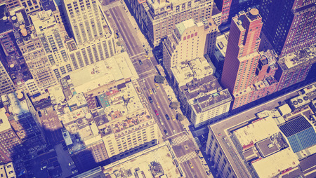 Vintage style aerial picture of Manhattan street with shadow of the Empire State Building, New York,...