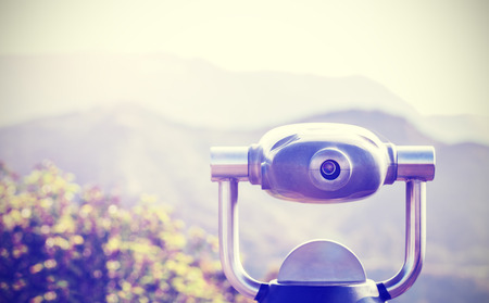 Vintage toned monocular pointed at horizon, shallow depth of field.の写真素材