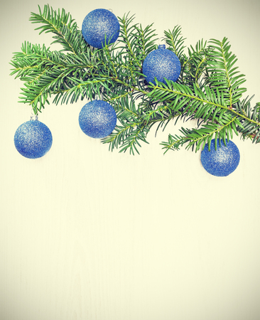 Retro toned Christmas decorations on a wooden board, copy space.の写真素材