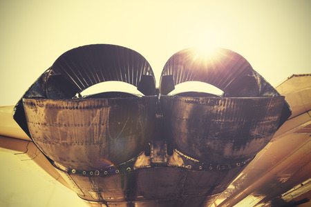 Retro toned jet exhaust pipes against sun.の写真素材
