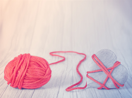 Wooden heart tied with red yarn, concept picture.の写真素材