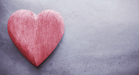 Vintage toned wooden heart on grunge background, space for text.の写真素材