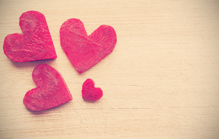 Retro stylized hearts made of beet on wooden background, space for text.の写真素材