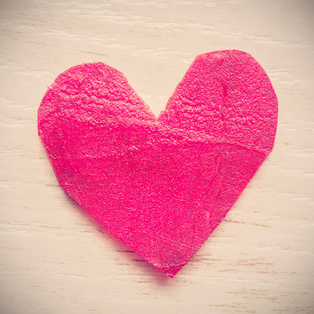 Vintage stylized heart made of beet on grunge background, space for text.の写真素材