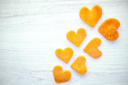 Retro stylized hearts made of carrot on grunge background, space for text.の写真素材