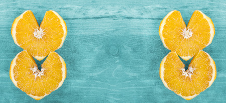 Background with heart shape orange slices, space for text.