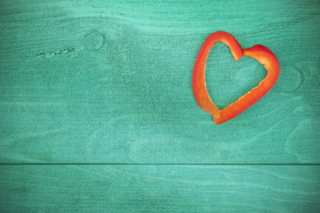 Vintage stylized heart made of pepper on grunge background, space for text.の写真素材