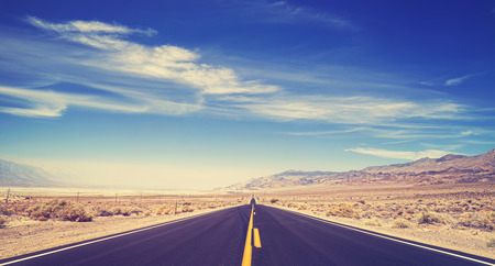 Vintage toned endless country highway, Death Valley, USA.の写真素材