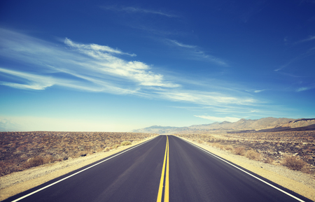 Vintage toned endless country highway, Death Valley, USA.の写真素材