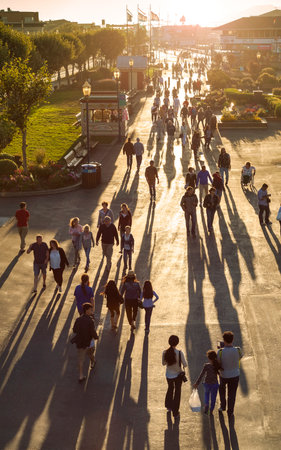 San Francisco, USA - August 25, 2015: Promenade by the famous Pier 39 crowded with people at sunset.のeditorial素材