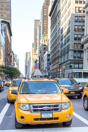 New York City, USA - August 15, 2015: City cabs waiting in a traffic on street of Manhattan. Yellow...