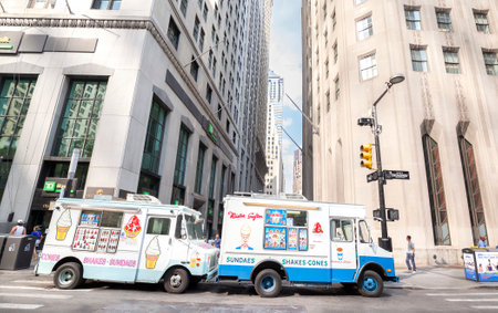 New York, USA - August 16, 2015: Ice cream trucks delivering sundaes and cones parked in front of the Wall Street.のeditorial素材