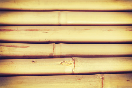 Retro toned grunge background made of bamboo sticks, shallow depth of field.の写真素材