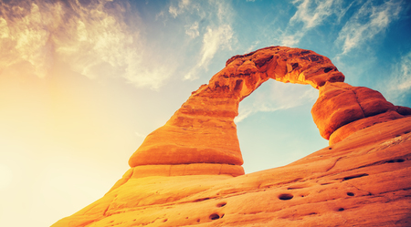 Vintage toned Delicate Arch at sunset, Arches National Park in Utah, USA.の写真素材