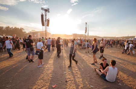 Kostrzyn nad Odra, Poland - August 1, 2015: People waiting for concert at sunset on the 21th Woodstock Festival Poland (Przystanek Woodstock).のeditorial素材