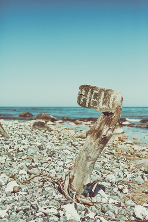 Vintage stylized help word written on an old wooden board, conceptual picture, shallow depth of field.の写真素材