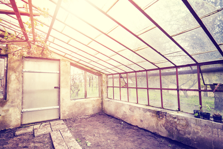 Vintage toned wide angle picture of an old empty glasshouse.の写真素材