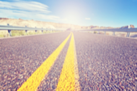 Vintage toned blurred road, travel concept background.