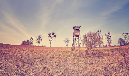 Vintage toned fisheye lens panoramic photo of a hunting pulpit on a field, Poland.の写真素材