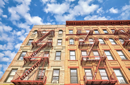 Residential building with fire escape ladders in New York City, USA.の写真素材