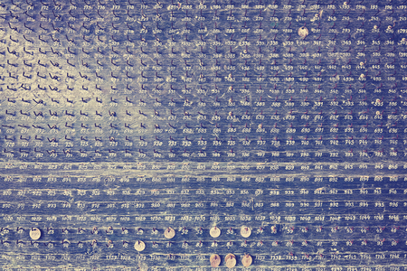 Vintage stylized old wooden board with hooks, tags and numbers.の写真素材