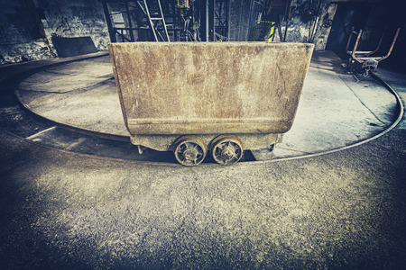 Retro toned old rusty mine cart, obsolete mining equipment.の写真素材