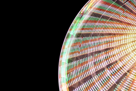 Blurred abstract background made of ferris wheel at night, long exposure picture.の写真素材