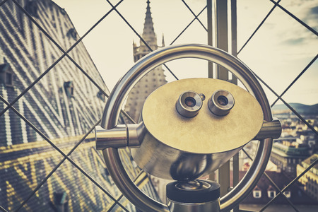 Retro toned tourist binoculars over Vienna, view from the north tower of St. Stephen's Cathedral.の写真素材