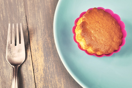 Retro toned homemade muffin cup cake on a plate.の写真素材