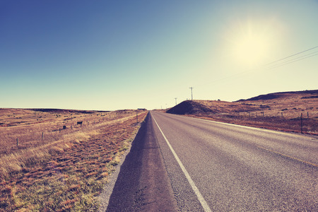 Vintage toned countryside road at sunset, USA.の写真素材