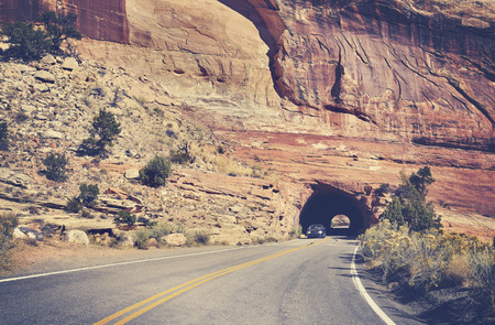 Vintage toned road through rock tunnel, Colorado National Monument, Colorado, USAの写真素材