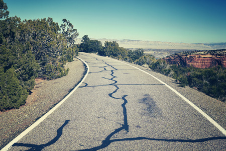 Retro stylized scenic road, travel concept background, Colorado, USA.