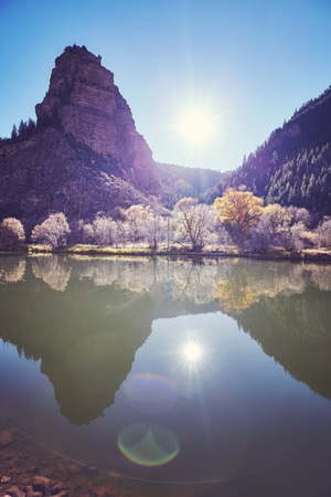 Beautiful mountain sunrise with lens flare effect, color toned picture, Colorado, USA.の写真素材