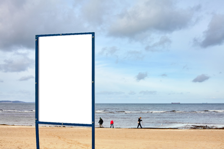 Empty board on a beach, space for text, selective focus.の写真素材