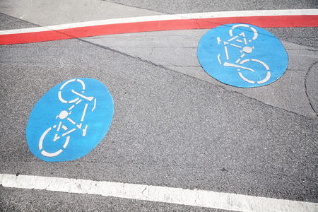 Bicycle lane blue sign on an asphalt street.の写真素材