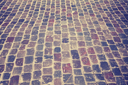 Vintage toned old cobblestone street, background or texture, selective focus.の写真素材