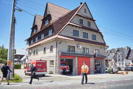 Bialka Tatrzanska, Poland - June 15, 2017: Firefighters rush to respond to emergency call during Corpus Christi procession.のeditorial素材