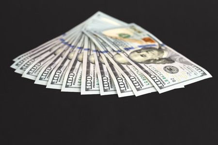 One hundred dollar bills, shallow depth of field.