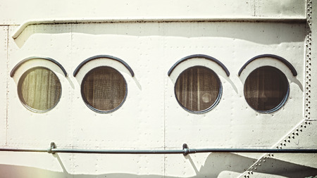 Retro stylized close up picture of an old ship portholes.の写真素材