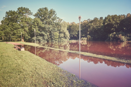 Vintage toned picture of a flooded pathway in a city park after heavy rain.の写真素材