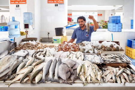 Ajman, United Arab Emirates - May 03, 2017: Man sells seafood at the local fish market.のeditorial素材
