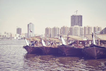 Fishing boats at Ajman fish market pier, color toning applied, United Arab Emirates.の写真素材