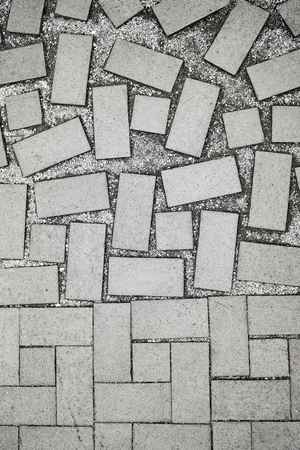 Black and white picture of sidewalk bricks, abstract background or texture.