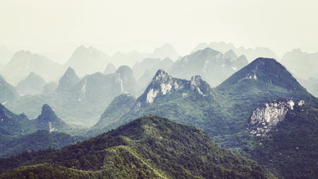 Retro toned picture of karst formations landscape around Guilin on a foggy day. It is one of China most popular tourist destinations.の写真素材